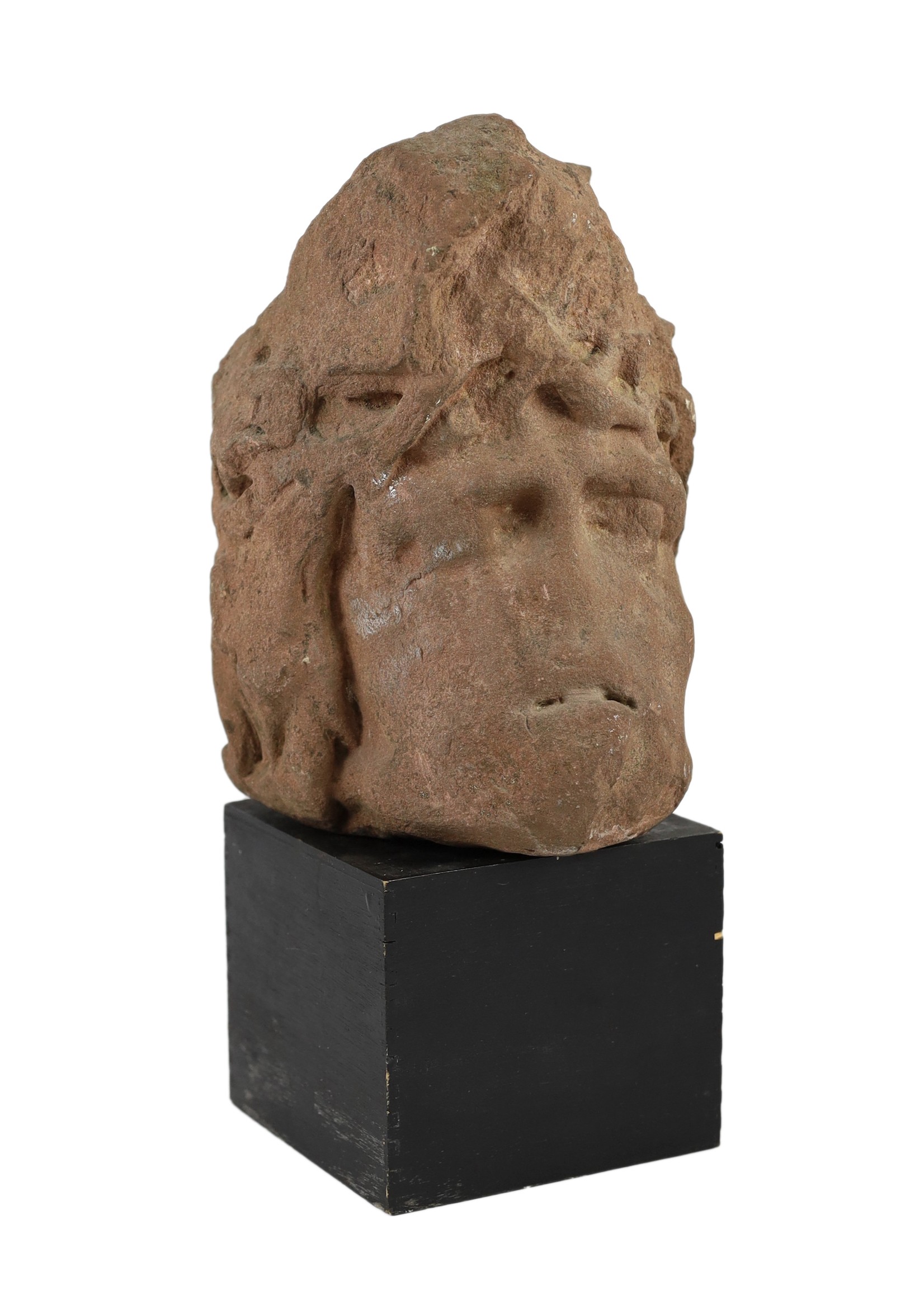 A weathered sandstone head of Christ, probably 12th century, 26cm high